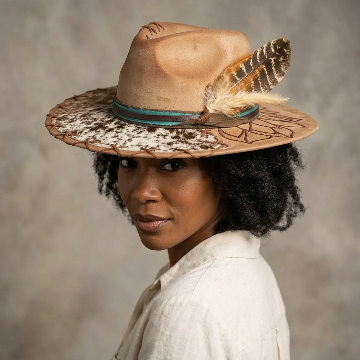Tan Felt Cowboy Hat with Cow Print Brim and Feather Trim